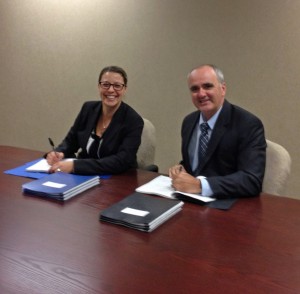 ACFO President Milt Isaacs and Treasury Board Negotiator Karine  Renoux sign the FI Collective Agreement on Sept. 30, 2013.